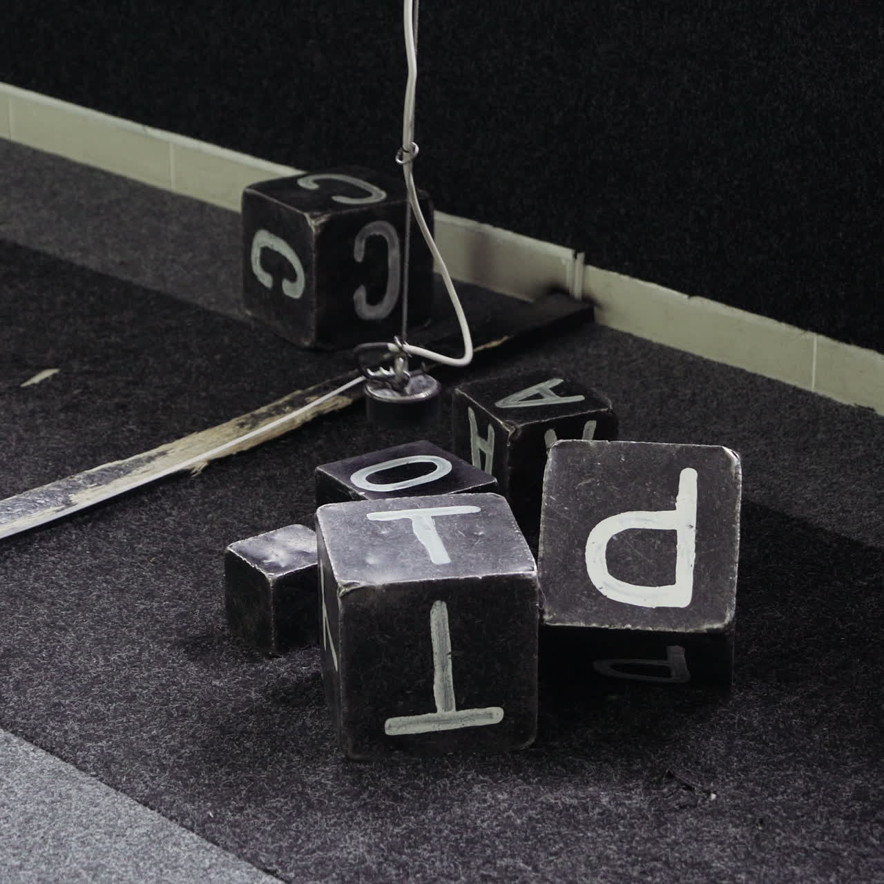 Transportation of steel cubes using a magnet. Boy sits in the excavator simulator and plays with the joystick.