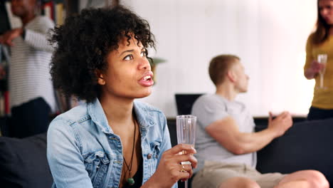young black woman talking at party in an apartment, close up