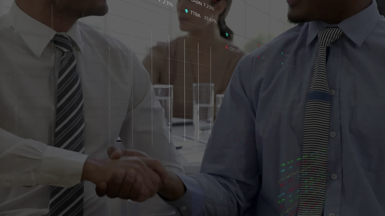 Stock market data processing against two diverse businessmen shaking hands at office