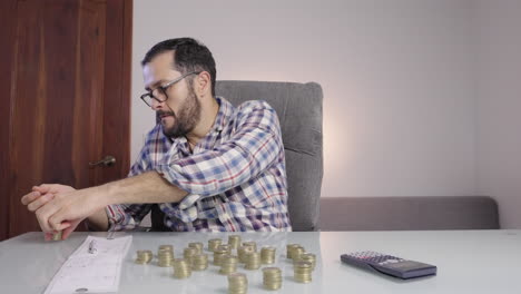 happy saver man counts coins celebrates euphoric with his hands