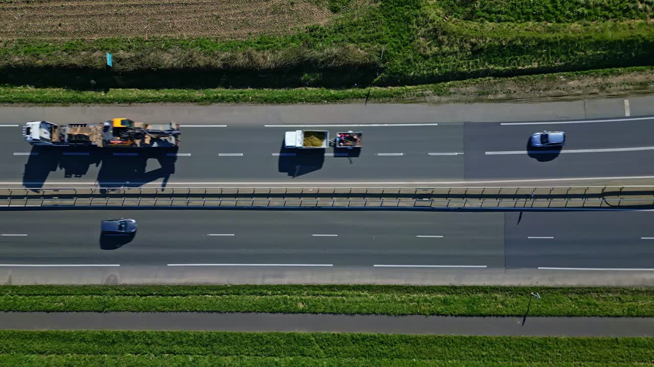 Cars driving along busy highway lanes. Aerial top-down view