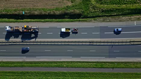 cars driving along busy highway lanes. aerial top-down view