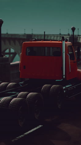 a red semi truck driving on a highway at night.