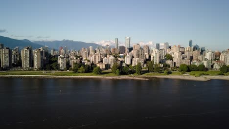 downtown skyline, skyscrapers and english bay seen from the famous kitsilano beach, kits beach in vancouver, british columbia, canada