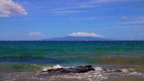 hawaii sand shore rock distant mountain slow motion 1