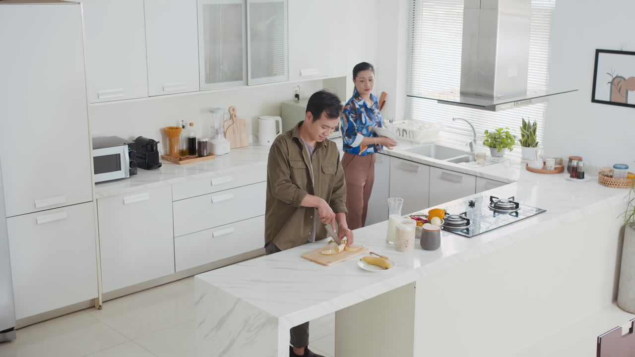 Asian Spouses Preparing Breakfast at Home Kitchen
