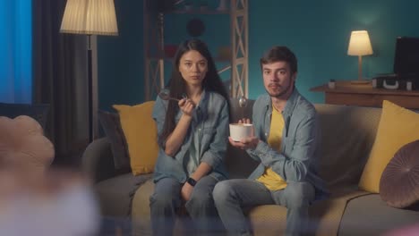 couple enjoying dessert at home