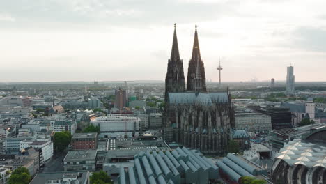 drone moves epic towards the cologne cathedral, it comes very close to the cologne cathedral and you can see the sunbeams shining through the towers, cinematic intro