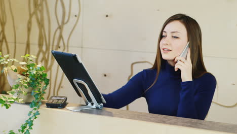 Young-administrator-speaks-on-the-phone-with-the-client-and-takes-orders