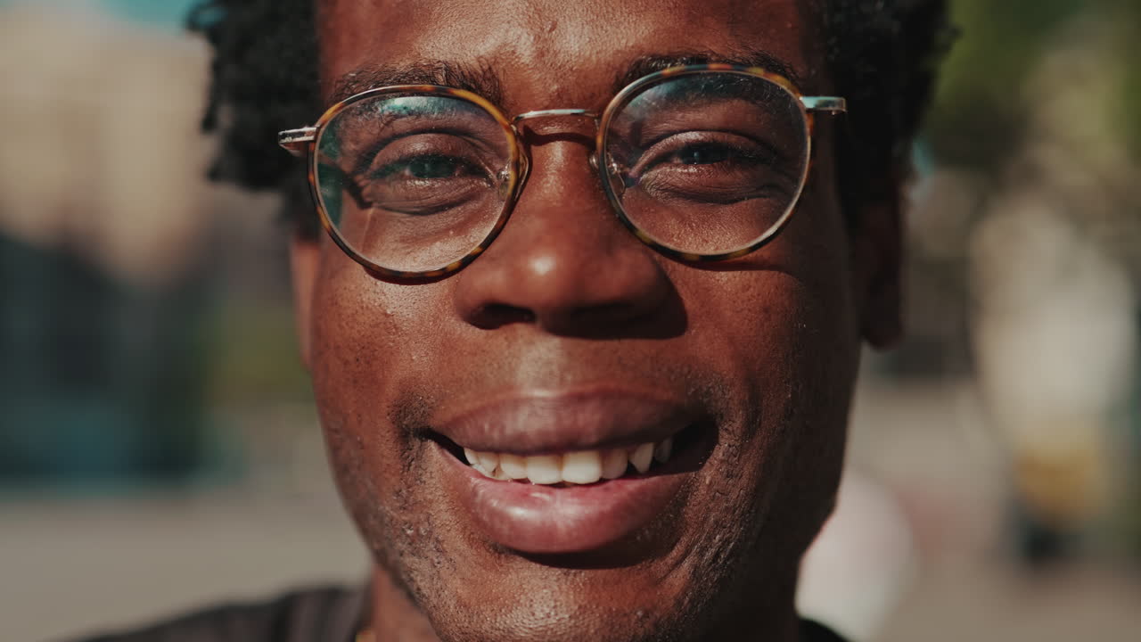 Happy Young Black Man in Glasses Smiling at Camera