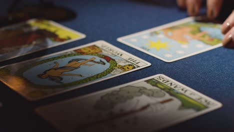 close up of woman giving tarot card reading on candlelit table 7