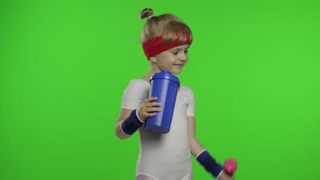 Girl-in-sportswear-making-fitness-exercises-with-dumbbells-and-drinking-water.-Little-athletic-child