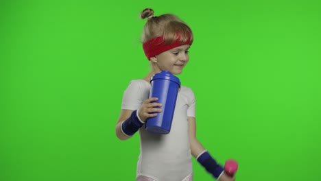 girl in sportswear making fitness exercises with dumbbells and drinking water. little athletic child