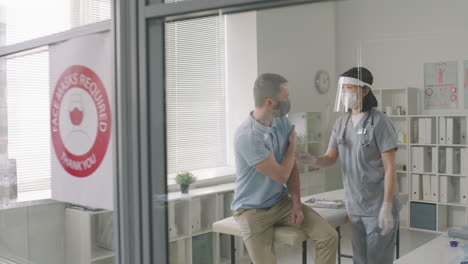 caucasian man gets vaccinated against covid