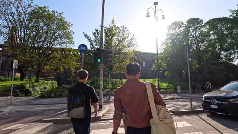 people crossing street near sforzesco castle, milan