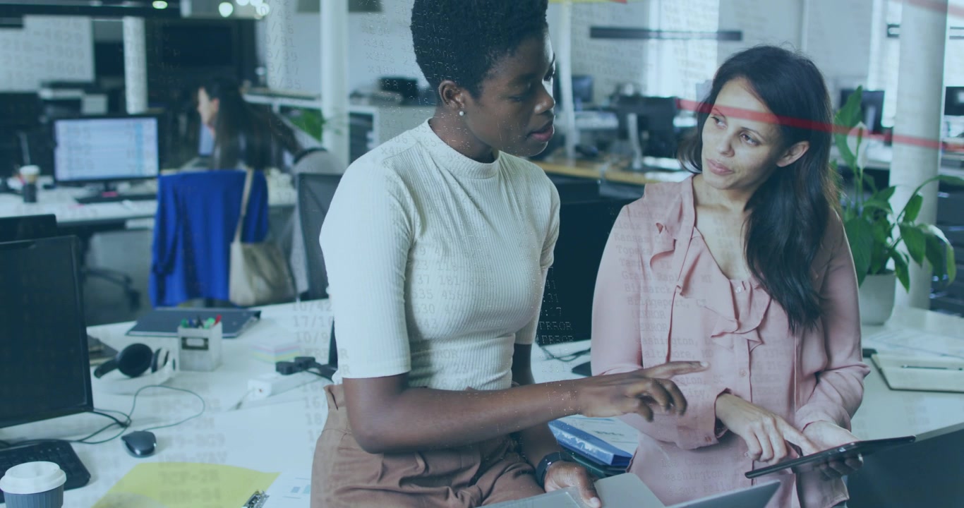 Seated woman pointing at laptop and woman tapping tablet, starting business review with red overlay