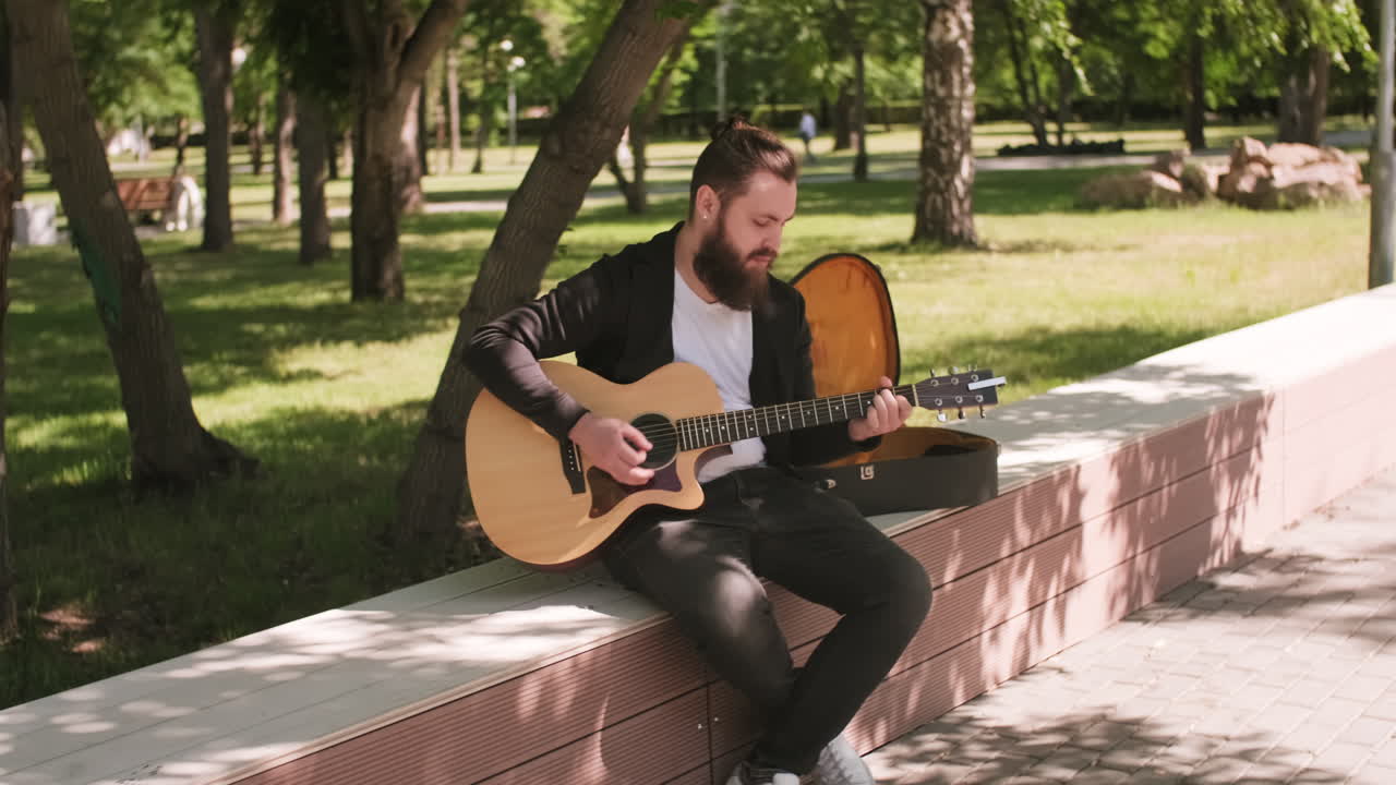 Male Street Musician Playing Guitar Outdoors