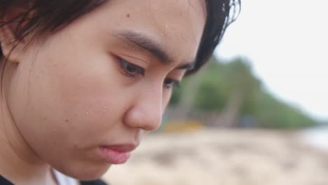 a young woman’s face reflects her depression, showing signs of mental illness - close up