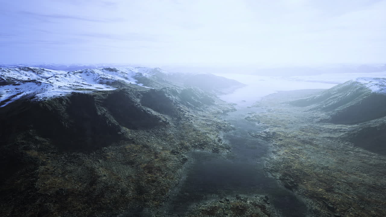 Peaceful winter landscape with mountains and a tranquil river in the distance