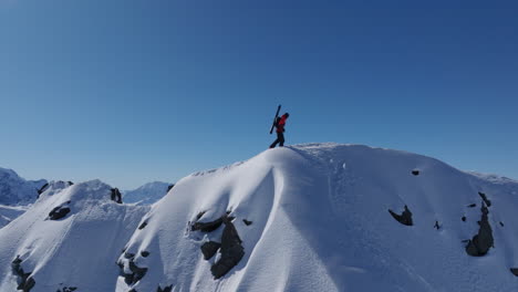 a professional skier hikes up a steep ridge in verbier, then drops into an epic freeride descent. pure adventure skiing in deep snow, dramatic terrain, and breathtaking alpine scenery.