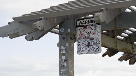 Quirky-artistic-modern-design-of-warning-sign-hanging-at-Hawaiin-beach