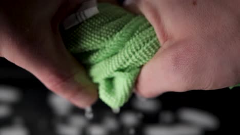 wring out a green rag in slow motion