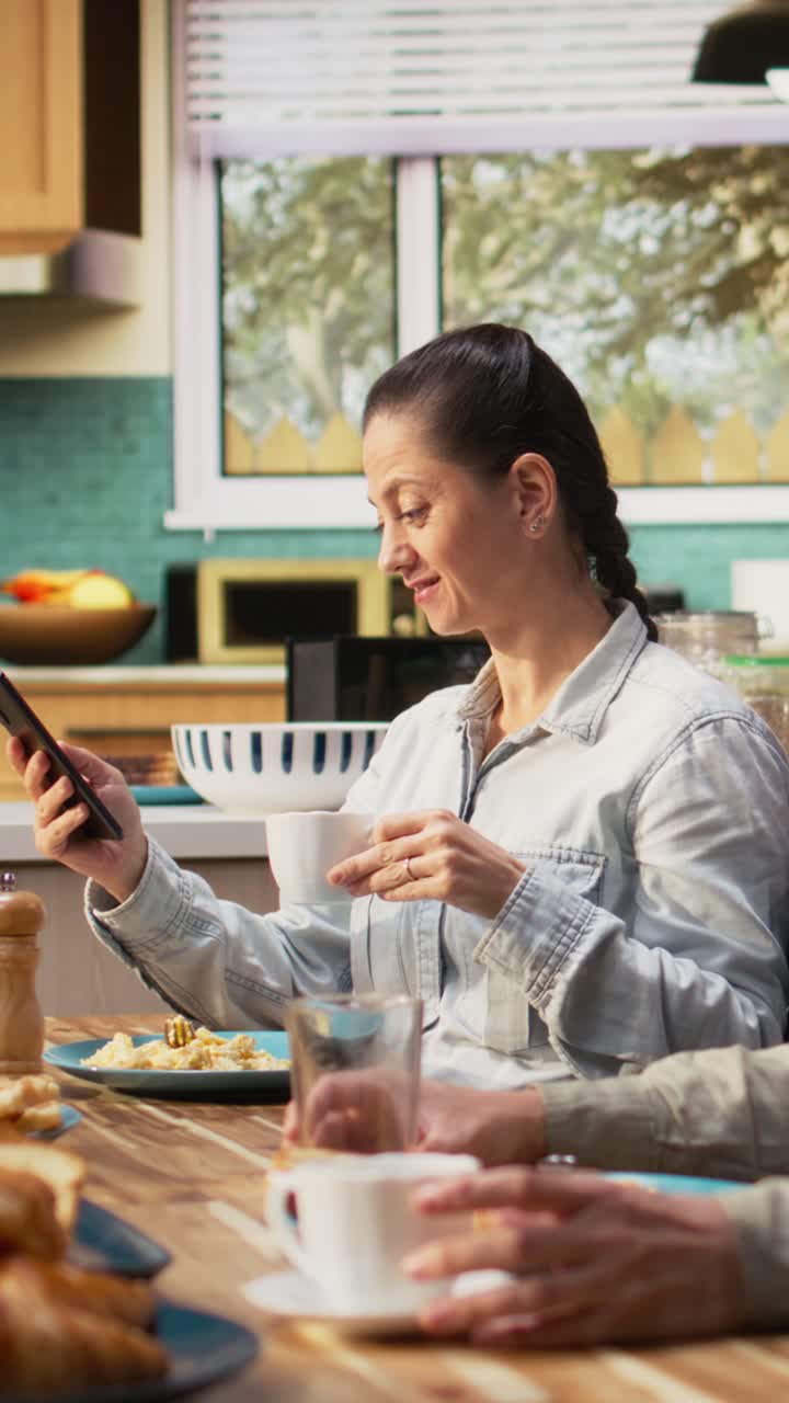 Vertical Video Family with a pre-teen girl serving breakfast together in a bright kitchen