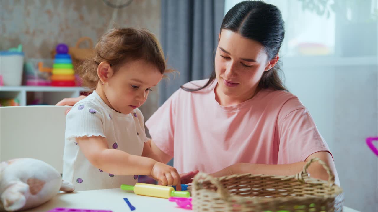 A Heartwarming Moment of Creativity: A Young Child and Her Parent Engage in Playful Learning with Colorful Toys at Home, Strengthening Their Bond Through Imaginative Play