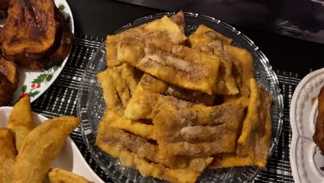 Traditional-portuguese-Christmas-sweets-Filhoses-with-sugar-and-cinnamon-on-kitchen-countertop