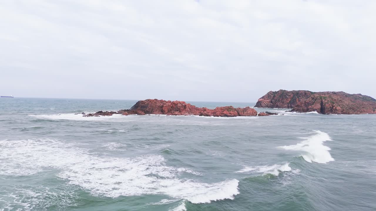 Aerial View Pan of the Rocks in the Water.