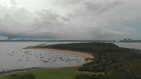 Drone-shot-over-an-island-with-boats-on-a-bay