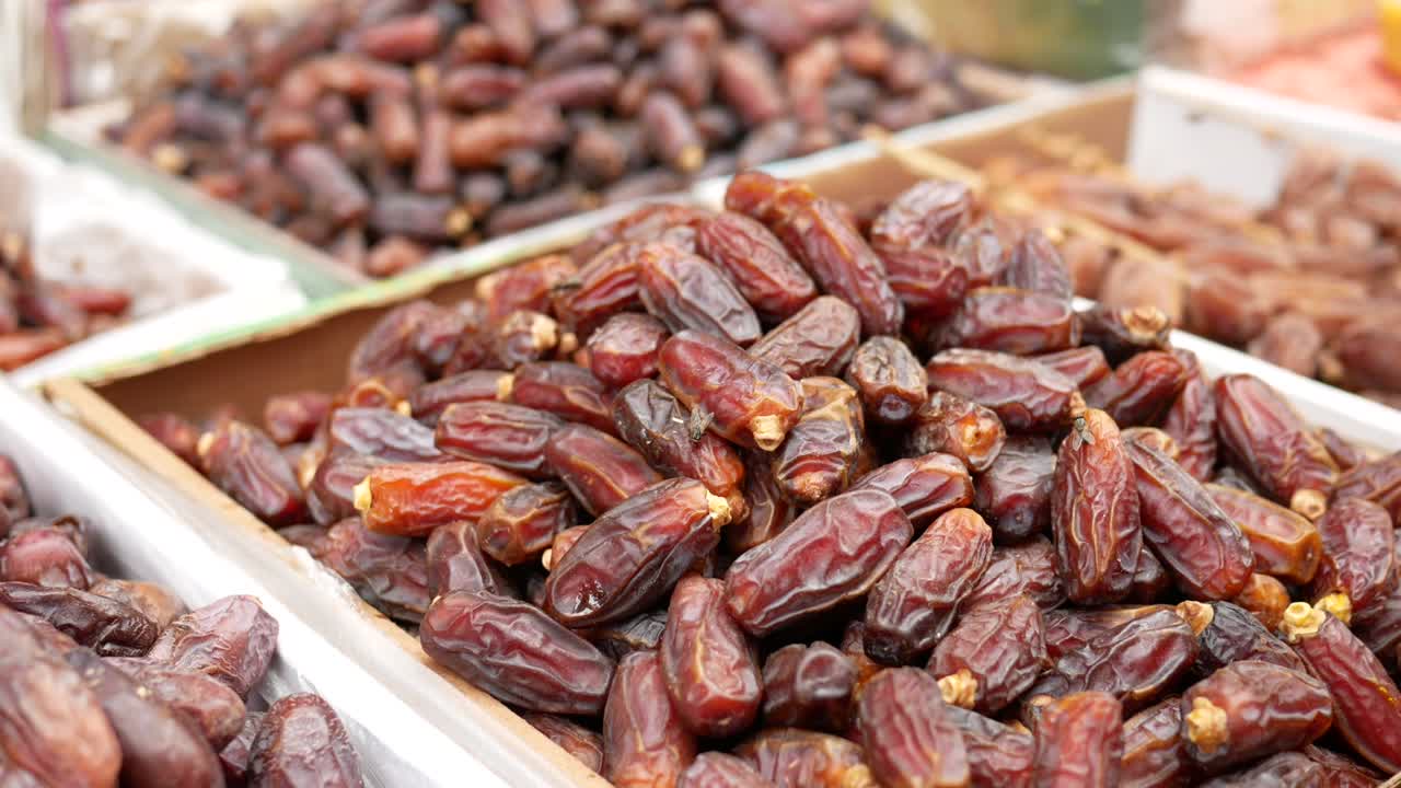 many date fruits display for sale at local market .