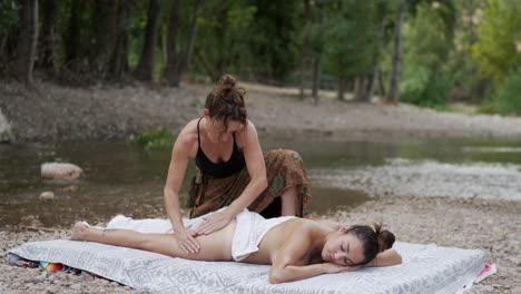 woman doing massage on lake shore