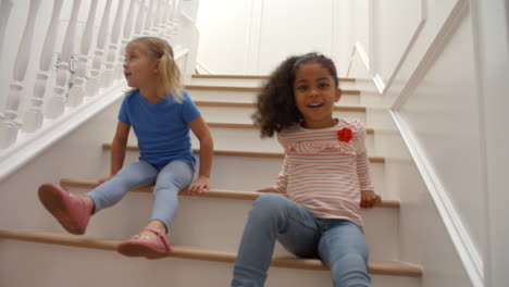 two girls playing on staircase shot in slow motion