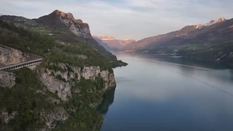 beautiful drone shot of the walensee lake and surrounded mountains, part of the lake, green hills, trees