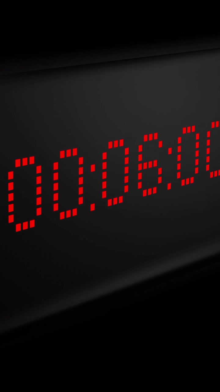 Animation of red digital timer changing on black background
