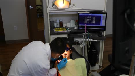 Male-dentist-examining-a-patient-with-tools-4k