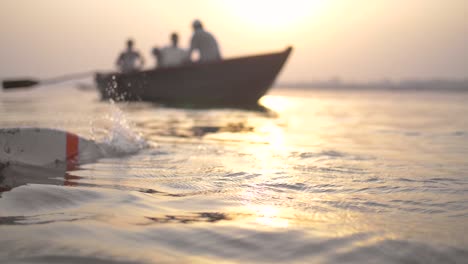 oar in the water at sunset