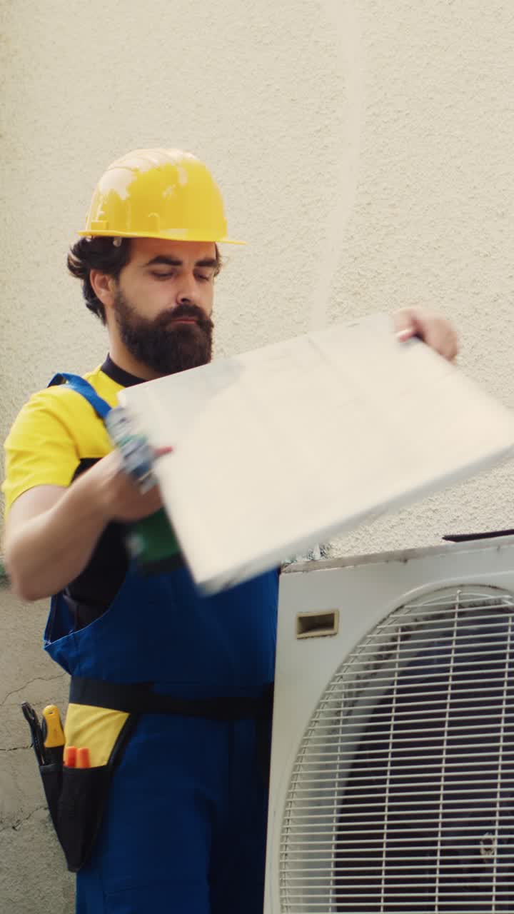 Vertical video Engineer dissasembling air conditioner