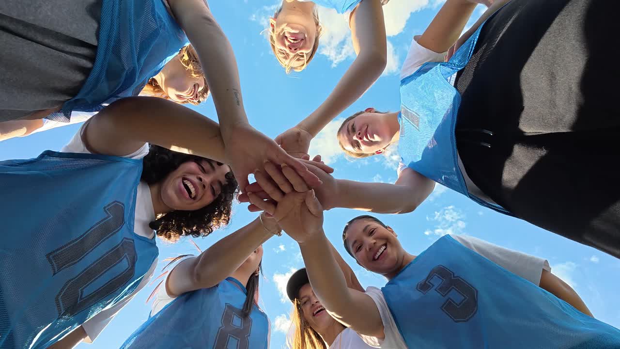 Team of people celebrating together under the sky
