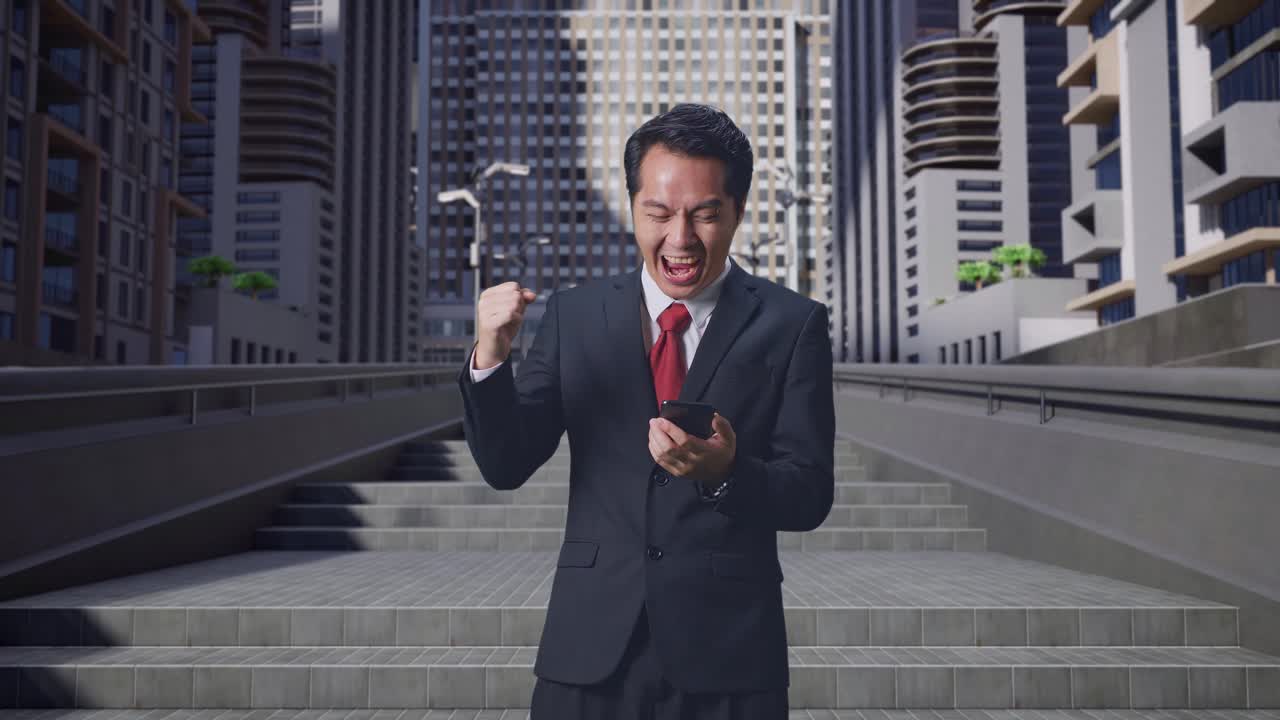 街でスマートフォンを使って祝う幸せなアジア人ビジネスマン