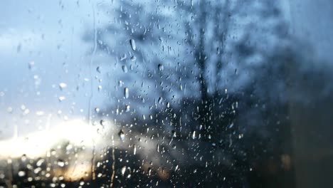 rainy storm droplets, moody weather fall down window glass closeup bokeh