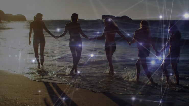 Animation of networks of connections over happy group of friends having fun, walking along beach
