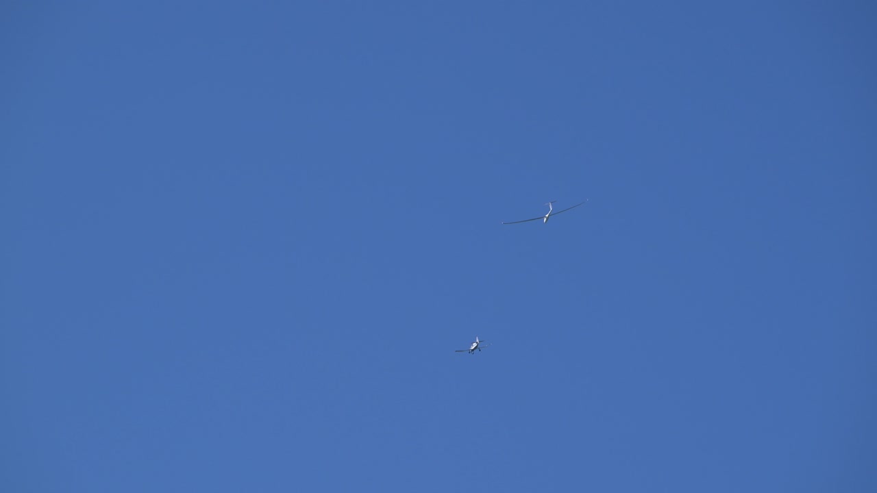 Plane towing glider in the skies of Lake Lucerne in Switzerland