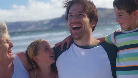 multi generation family enjoying at beach