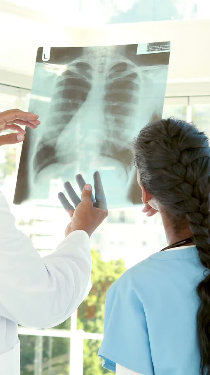 Doctors analyzing together xray