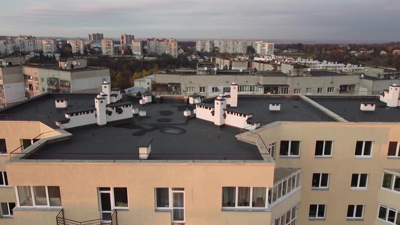 Aerial view of a drone flying over the buildings, roof shooting and architecture.