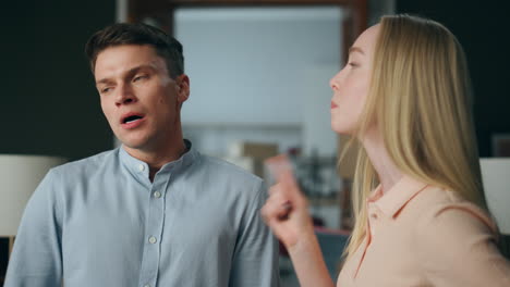 emotional family conflict home closeup. angry man arguing with nervous woman.