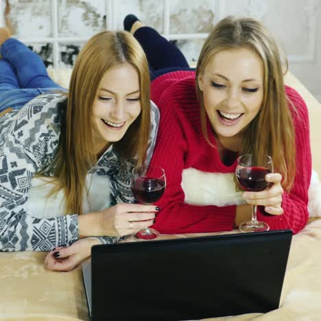 women talking on skype holding glasses of wine