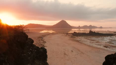 the dry reef of kuta lombok during sunrise, with local people looking for food and seashells